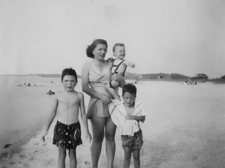 Vintage family photo of a grandmother with children at the beach